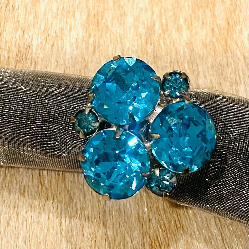 Vintage jewelry ring set on a new silver plated ring base. Adjustable, sz 6-10